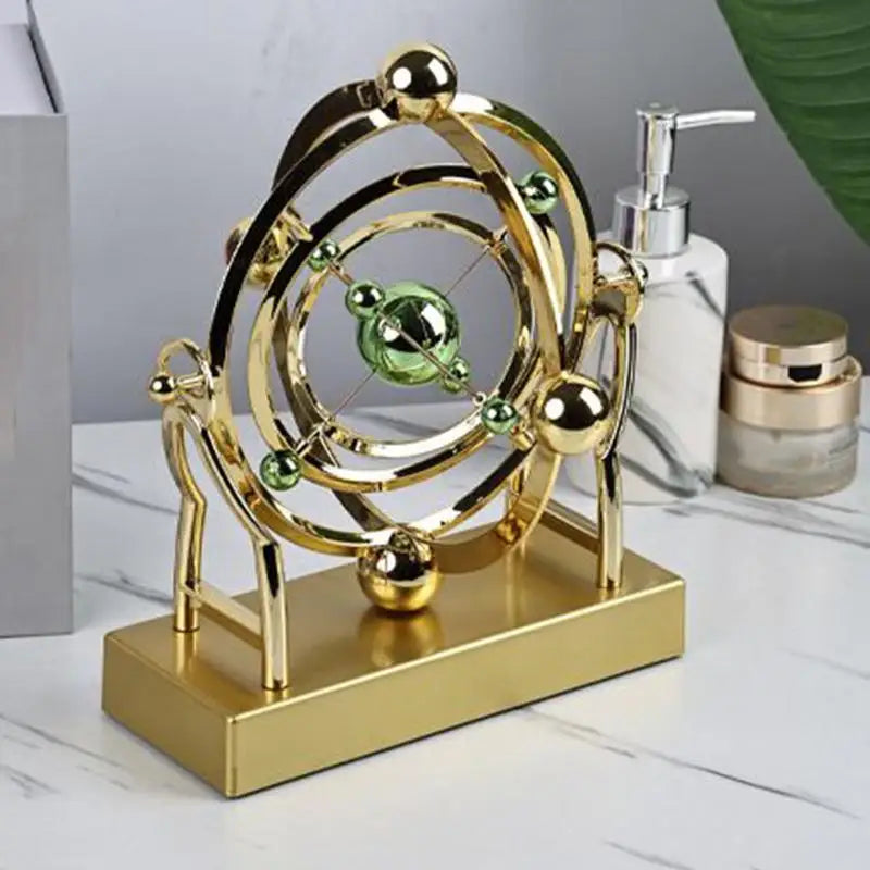 gold celestial orbit perpetual motion sculpture cosmic kinetic desk decor