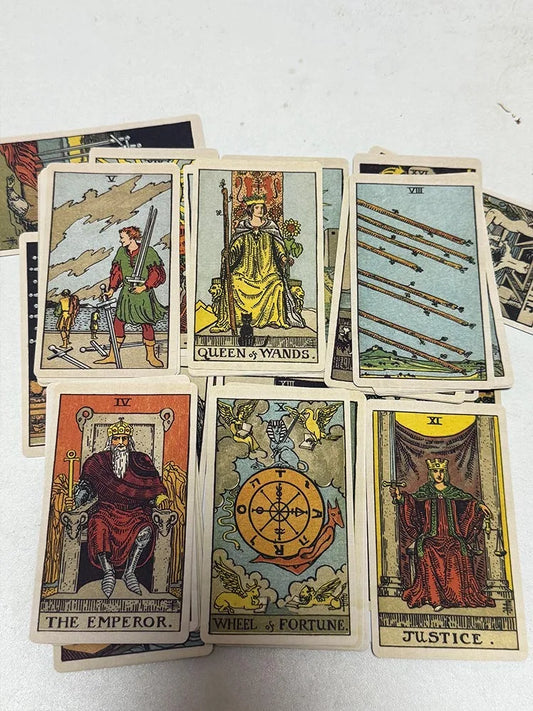 Classic tarot cards laid out featuring The Emperor, Wheel of Fortune, Justice, Queen of Wands, and other traditional tarot imagery