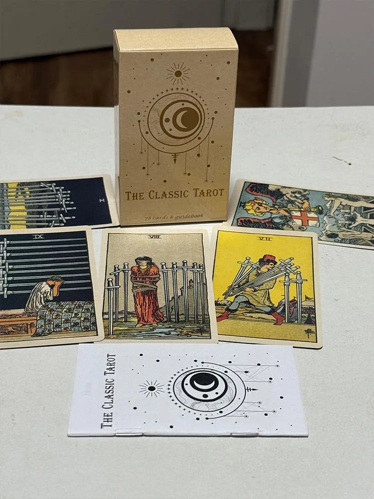 The Classic Tarot deck box standing upright with traditional tarot cards laid out in front, including swords and wands cards