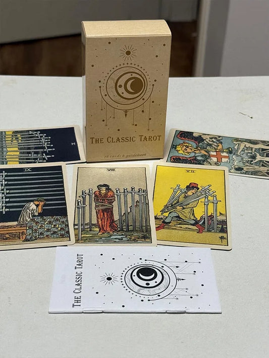 The Classic Tarot deck box standing upright with traditional tarot cards laid out in front, including swords and wands cards