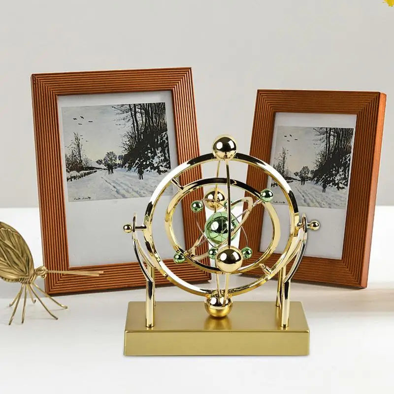 gold celestial orbit perpetual motion sculpture cosmic kinetic desk decor